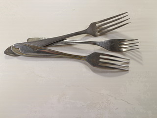 several table forks on the table