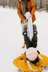 young couple have fun in the winter forest