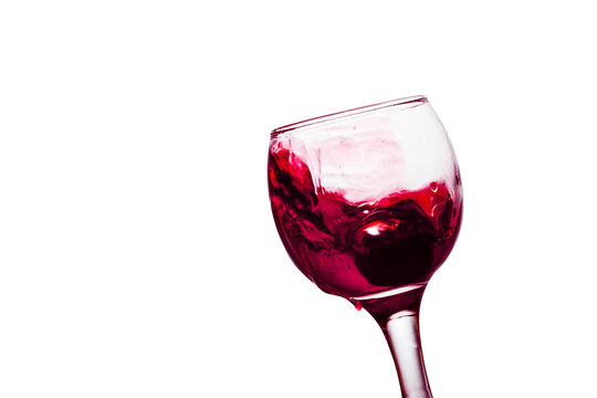 Splash Of Pink Wine In A Glass On A White Background