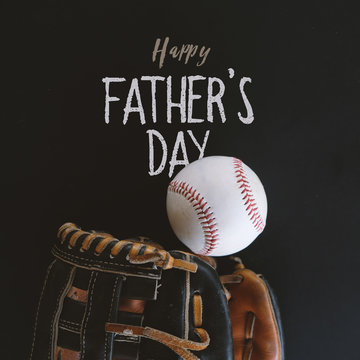 Happy fathers day baseball holiday graphic with handwritten style text on blackboard.