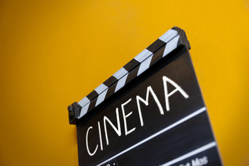 Naklejka premium cinema text title on wooden movie clapper 