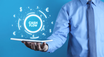 Man holding Cash Flow words with currency symbols. Finance concept