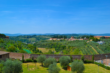 View of the green fields of the countryside of Tuscany from a lookout in San Gimignano, Italy.