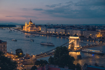 Beautiful view on the Danube promenade, Parliament and chain bridge at dusk, Budapest 