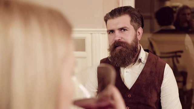 Couple in love. Handsome man flirting with cute woman in restaurant. Bearded man flirting with young sexy blonde
