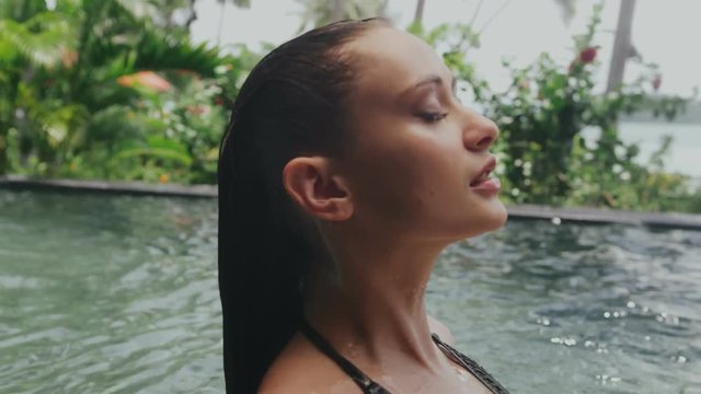 Young sexy girl resting and swimming in the pool