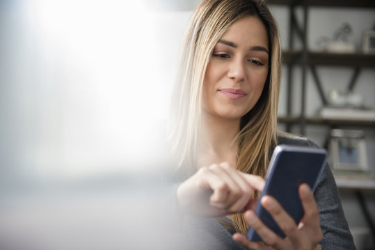 Young woman text messaging