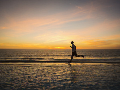 Man jogging along poolside