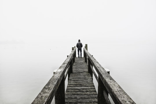 USA, Massachusetts, Cape Cod, Eastham, Man standing on jetty in fog