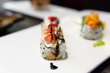 Sushi, a typical Japanese food prepared with a base of rice and various types of raw fish. In this case it is stuffed with strawberries, cheese, seaweed and vinegar cream.