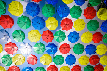 Multi-colored umbrellas background. Colorful umbrellas floating above the street. Street decoration.