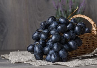 Grapes in a basket on a table on a neutral background