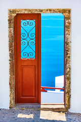 Naklejka premium Aegean sea through the open door in Santorini,