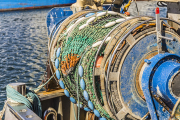 fishing boat in the harbor - detail shot from fishing net