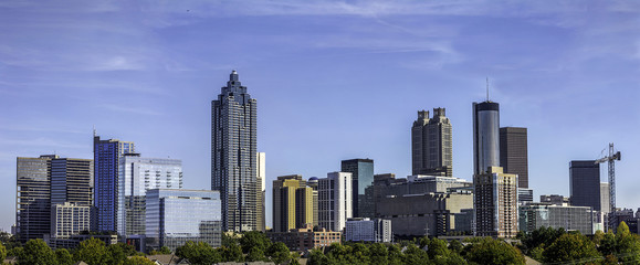 Downtown Atlanta Skyline showing several prominent buildings and hotels under a blue sky.