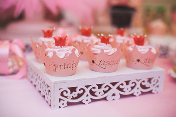 Close up pink cupcakes fo princess. Delicious wedding candy bar or birthday party dessert table. Candy Bar buffet with cupcakes at restaurant.