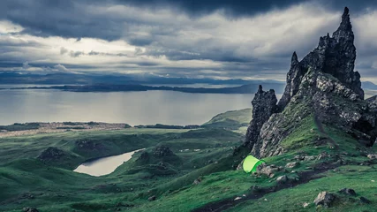  Rainy clouds over tent in Old Man of Storr, Scotland © shaiith