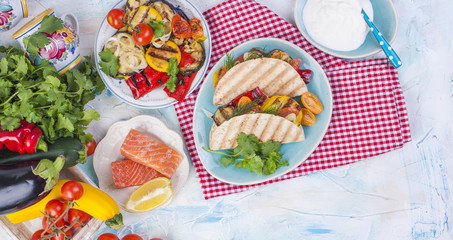 Mexican tacos with grilled vegetables and salmon. Healthy food for lunch. Fast food. Copy space.