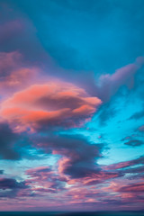 Breathtaking illuminated clouds at sunset over sea