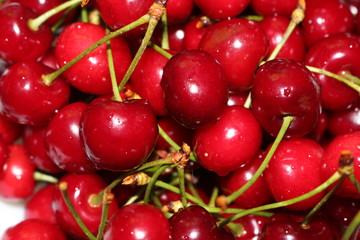Red ripe cherry lies on a plate