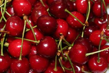 Red ripe cherry lies on a plate