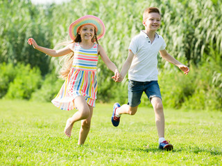 Obraz premium Two children running in park.