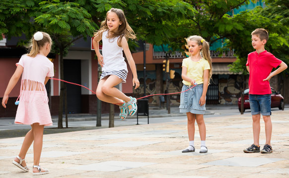 children with jumping rope at playground.