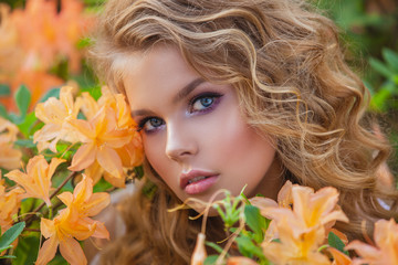 Portrait of a beautiful girl in a blooming garden. Hairstyle and make-up.