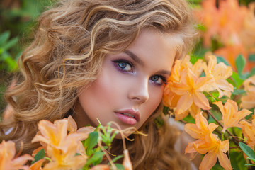 Portrait of a beautiful girl in a blooming garden. Hairstyle and make-up.