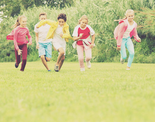 Company of kids are jogning together
