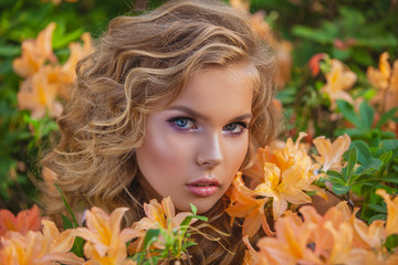 Portrait of a beautiful girl in a blooming garden. Hairstyle and make-up.