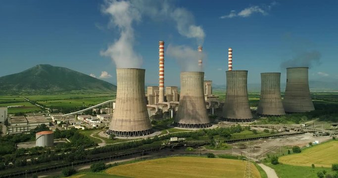 Flying over the plant producing electrical energy with large pipes at Kozani in northern Greece. Aerial shot