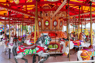 Carnival merry go round with pretty colorful horses