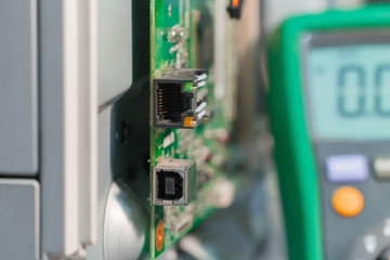 Electronic printed circuit board of laser printer with USB and RJ45 connectors and multimeter