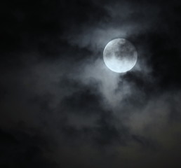 Naklejka na ściany i meble Rain clouds are moving on the night of the full moon.