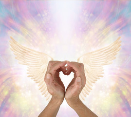 Sending Love and Gratitude to your Guardian Angel - female hands making a heart shape with golden...