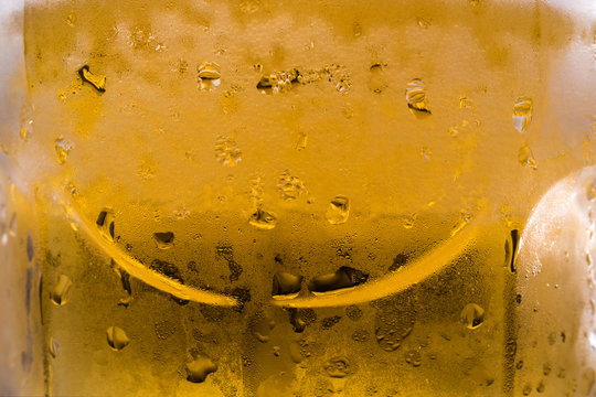 Refreshing and yellow super cold beer macro photo of detailed cold beer mug with drops falling in background