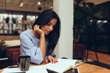 Businesswoman reading a book while sitting in office