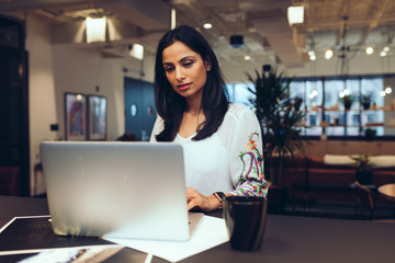 Businesswoman working on laptop in office