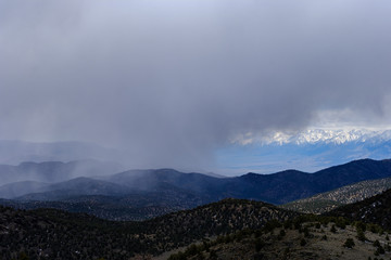 Rain and snow descend on the snow-capped White Mountains of Eastern California