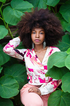 Portrait of young woman in foliage