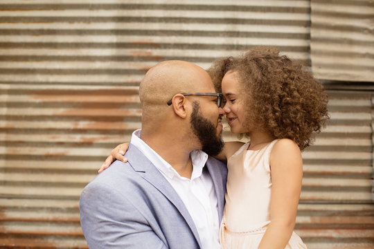 Smiling father carrying daughter outdoors