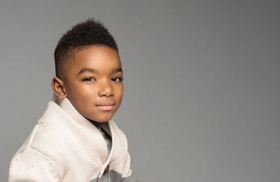 Portrait Of Boy Against Gray Background