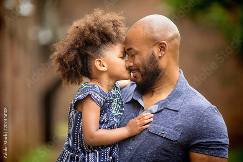 Father carrying daughter outdoors
