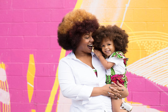 Smiling Mother Holding Daughter