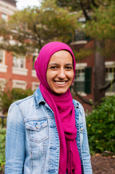 Portrait of smiling woman standing at college campus