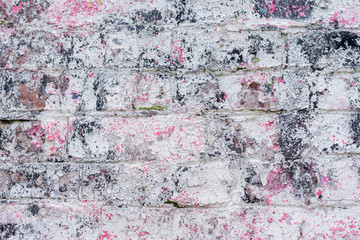 Abstract dirty painted brick surface close-up with pink paint. Colorful grunge texture of wall. Abstract modern background, copy space