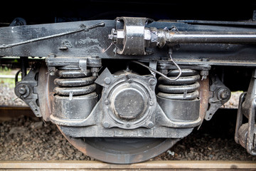Fototapeta na wymiar wheels of the railway car. Wheelbase of the train car close-up