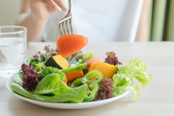 Food menu for dietary people. women eating tomato in variety vegetables in salad plate during diet.