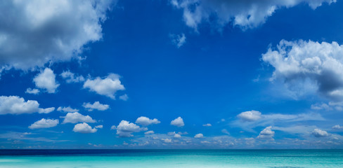 Beautiful sea and a blue sky with white clouds .